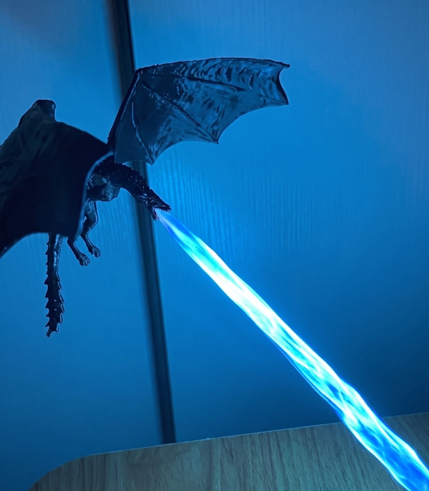 Dragon lamp breathing a beam of blue fire